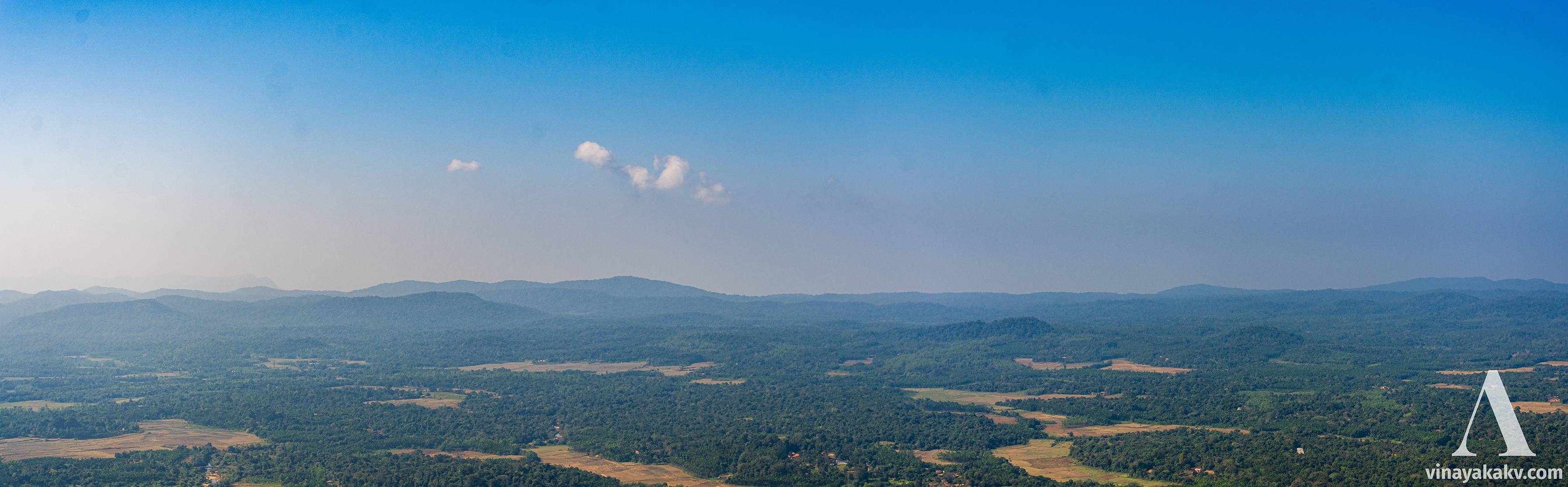 View from *Kundadri* on hazy day. The photo is processed to make the effect of haze appear less. The tower of Agumbe ghat is at the center of the photo and barely visible.