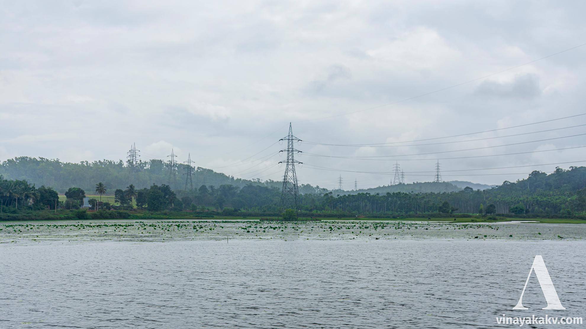 A lake with power lines, notice the terrain there is not so hilly